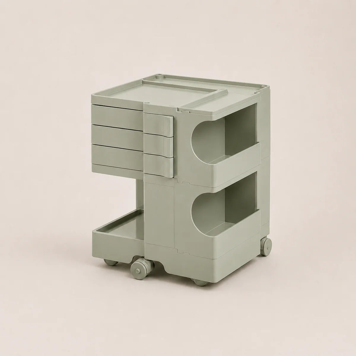 A light matcha green ABS plastic rolling storage cart with three drawers on the left, open shelves on the right, and caster wheels at the base, shown on a solid light beige background.