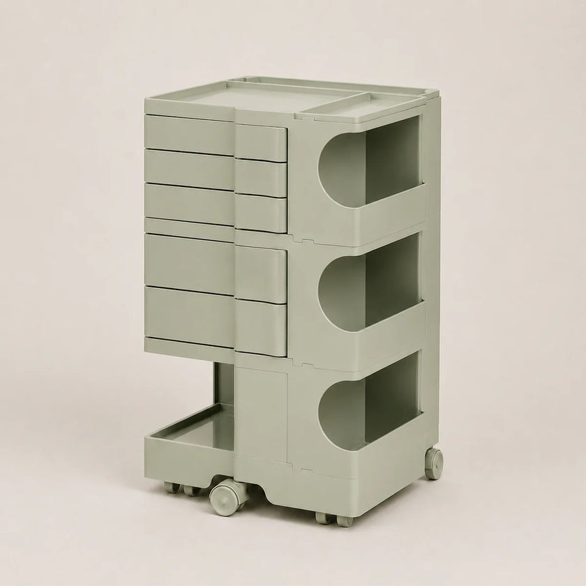 A light sage green storage cart with multiple drawers, open shelves, and a top tray, shown on a plain light beige background.