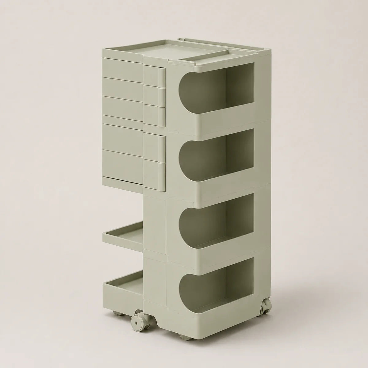 A light sage green storage cart with five tiers, featuring a stack of drawers on the upper left and open arch-shaped shelves on the right, set against a solid light beige background.