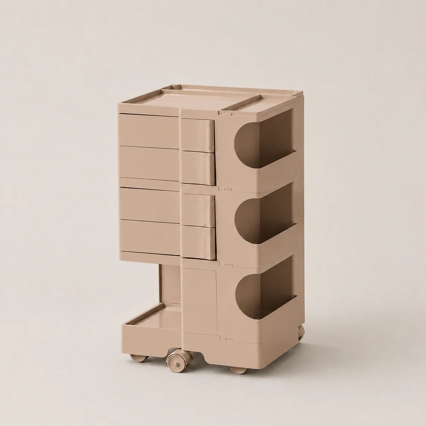 A muted pink plastic rolling storage organizer with four drawers on the left and three open shelves on the right, shown on a clean, light beige background.