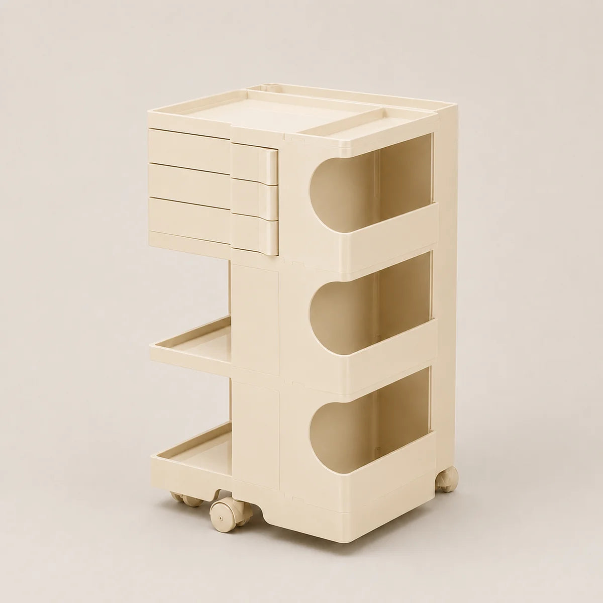 A cream-colored plastic rolling storage cart with three drawers, three open shelves, and wheels, shown on a neutral beige background.