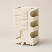 An off-white ABS rolling organizer with multiple drawers, open shelves, and a lower pull-out tray, shown on a neutral beige background.