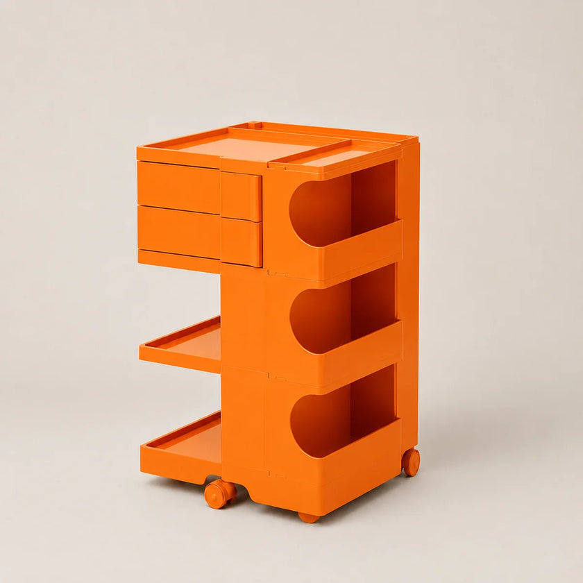 Orange rolling storage cart with two drawers, two open shelves, and open side compartments, photographed on a plain light gray studio background.