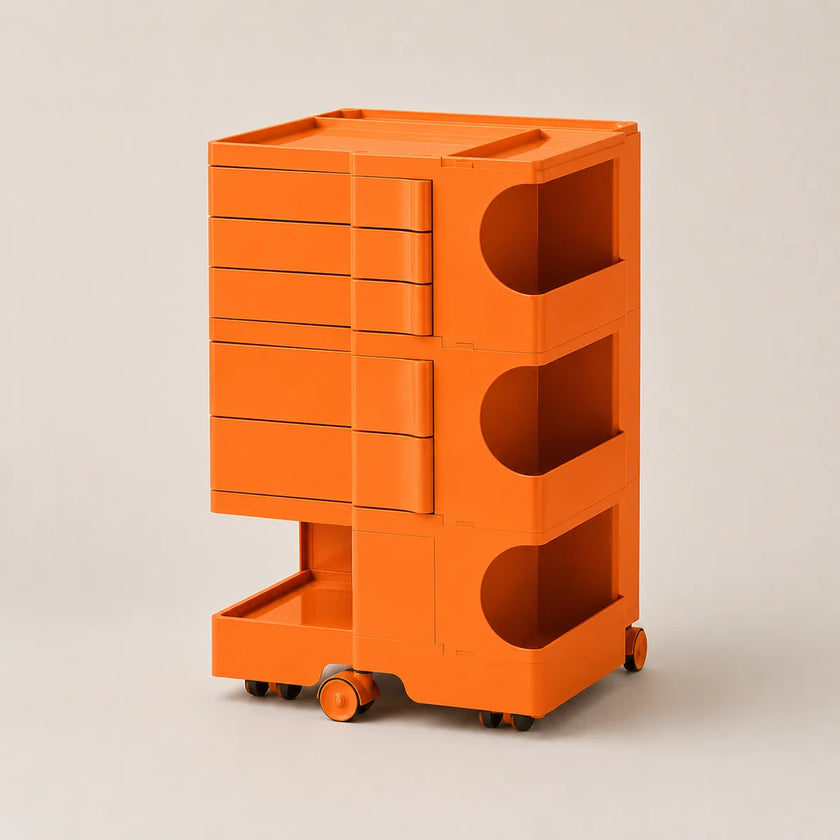 Bright orange storage cart with multiple drawers and open shelves on wheels, photographed on a clean light beige studio background.
