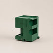 A vintage green ABS plastic storage cart with three drawers, open shelving, and small caster wheels, shown on a plain light beige studio background.
