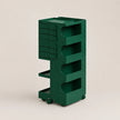 A dark green rolling storage cart with multiple drawers and open shelves, shown on a plain beige studio background.