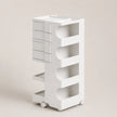 A white rolling storage organizer with four drawers on the left and four open shelves with curved cutouts on the right, shown on a plain beige studio background.