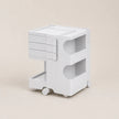 A white ABS plastic rolling organizer cart with three drawers on the left, two open storage compartments on the right, and a lower open shelf, shown on a light beige background.