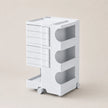 A white ABS rolling organizer cart with multiple drawers and open storage compartments, shown on a plain beige background.