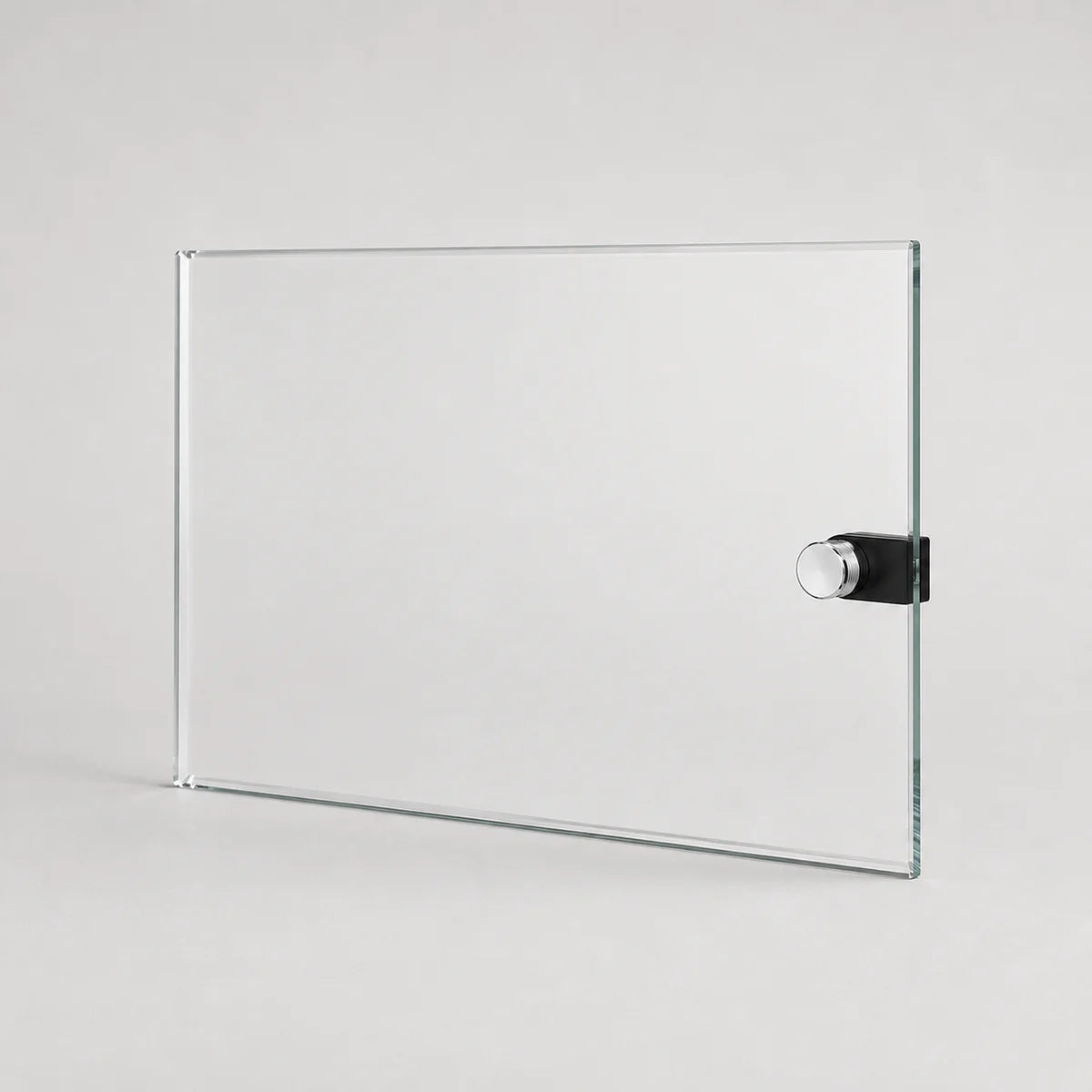 A clear rectangular glass board with a black and silver magnetic clip on the right side, shown on a light gray background.