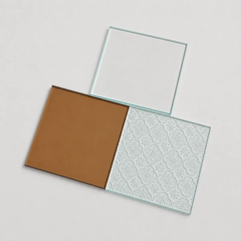 Three square glass panels arranged on a light gray background: one clear pane, one with a smooth warm brown tint, and one with a pale embossed floral pattern.