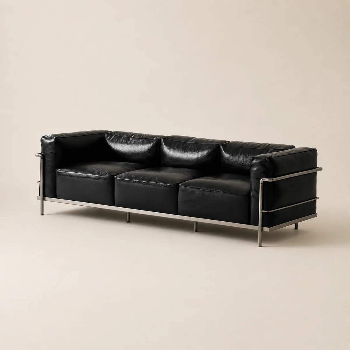 Black waxe microfiber leather three seats armchair with metal legs on a white background