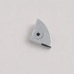 A small metallic silver metal component with a triangular shape and a circular hole, photographed on a plain light gray background.