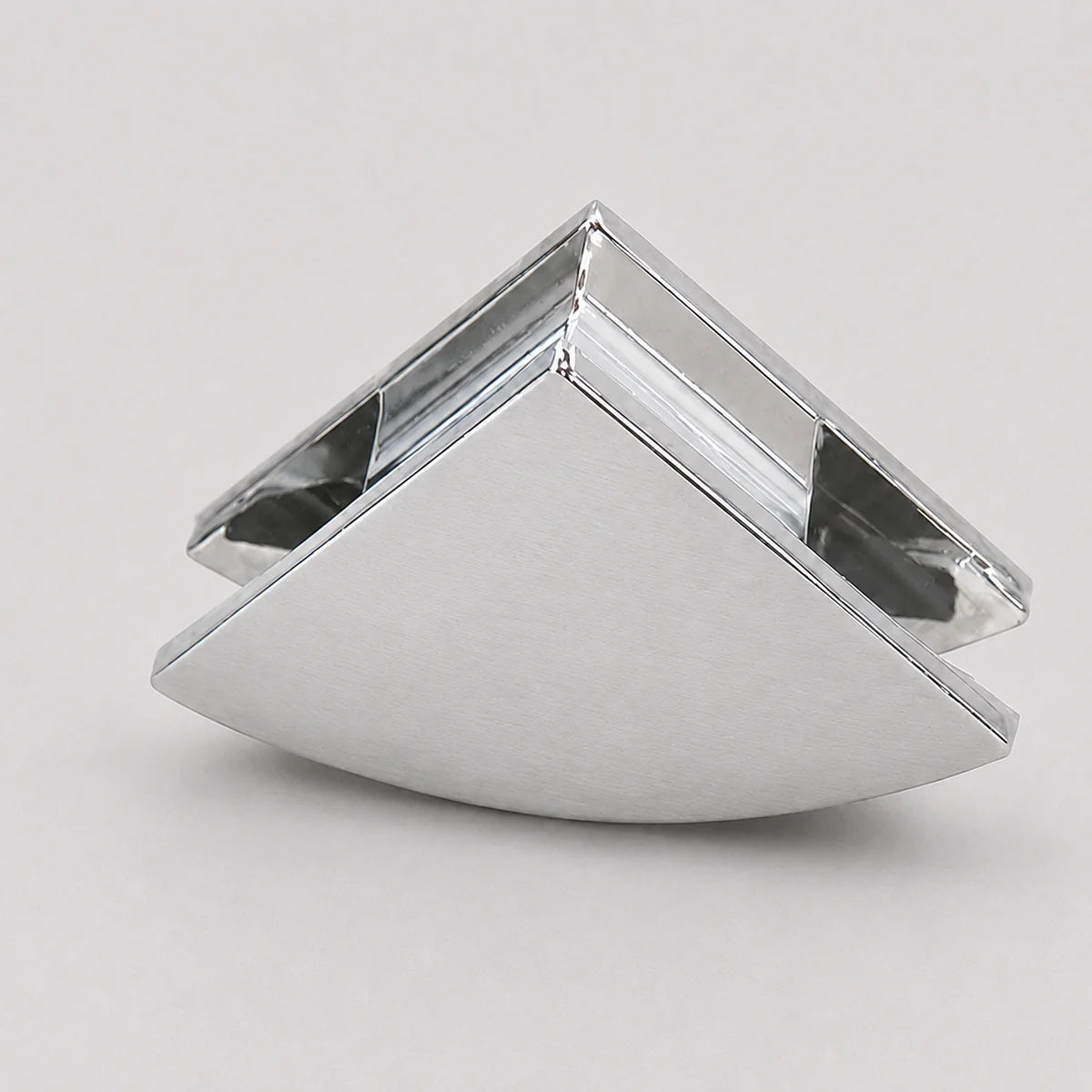 A modern geometric triangular wall hook or cabinet pull in a brushed silver metal finish, shown on a neutral light gray background.