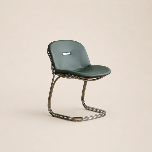 Green chair with metal frame on a beige background