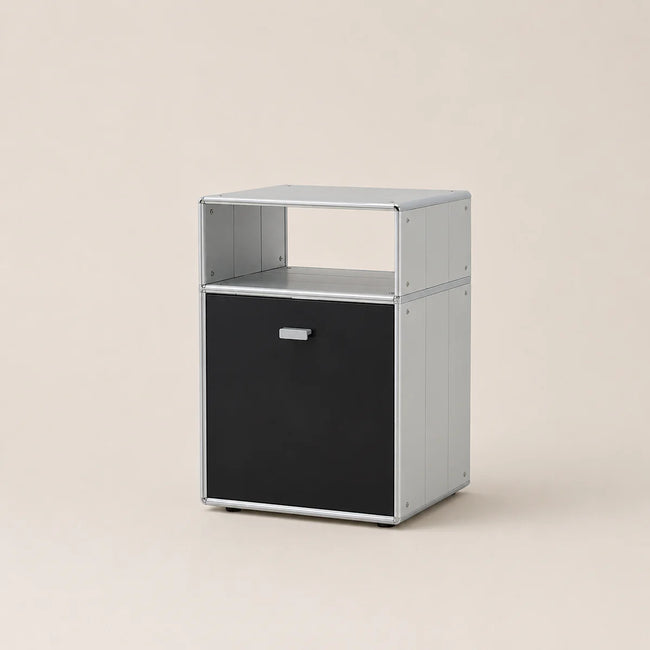 A modern two-tier storage cabinet with a silver aluminum frame and a black lower drawer, shown on a solid beige background.