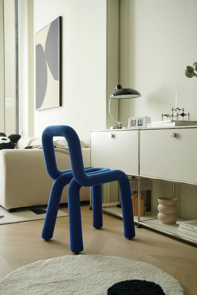 Blue vanity chair or kids chair in a modern living room with white furniture and decor.
