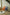 Two colorful kids chairs, one orange and one blue, in a room with a white rug and a small table with plants.