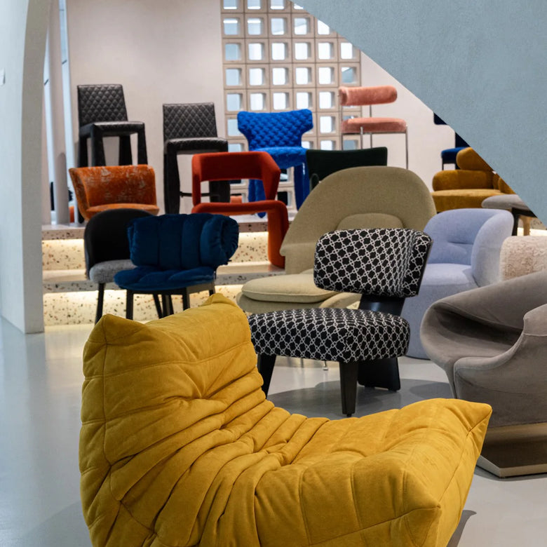 Colorful chairs and a yellow bean bag chair in a showroom setting.