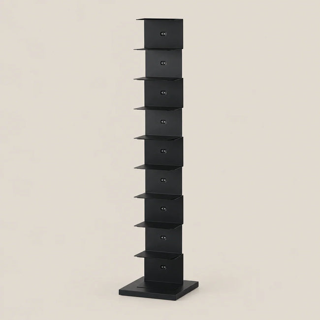 A tall, narrow black metal storage rack with multiple small shelves, shown against a plain warm beige background.