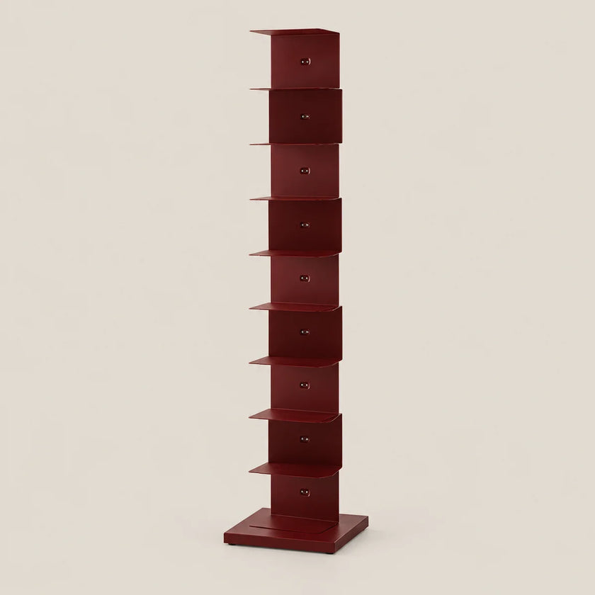 A tall, narrow red storage shelf with multiple compartments stacked vertically, set against a plain light beige background.