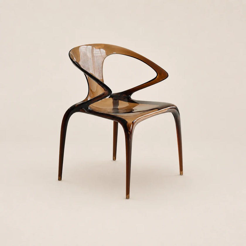Modern chair with a transparent backrest on a beige background
