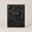 Black metal wall art with geometric shapes on a beige background