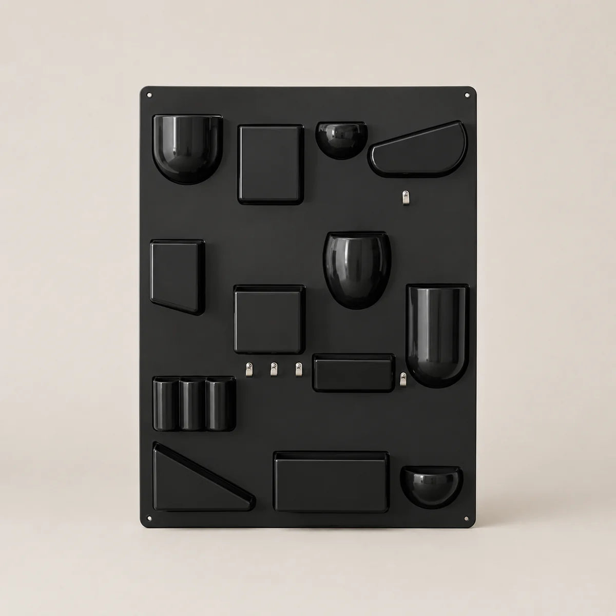 Black metal wall art with geometric shapes on a beige background