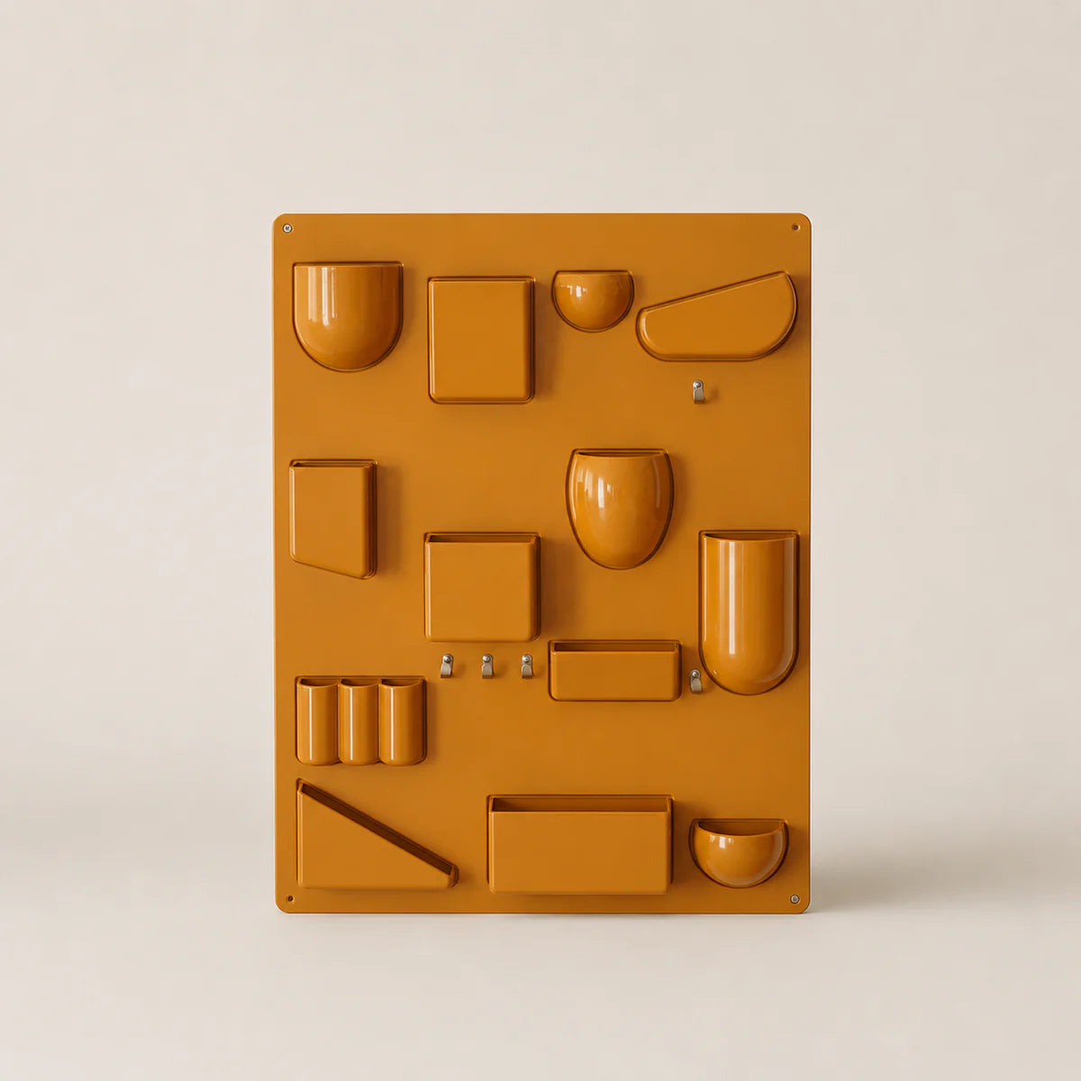Yellow plastic mold with various shapes on a beige background