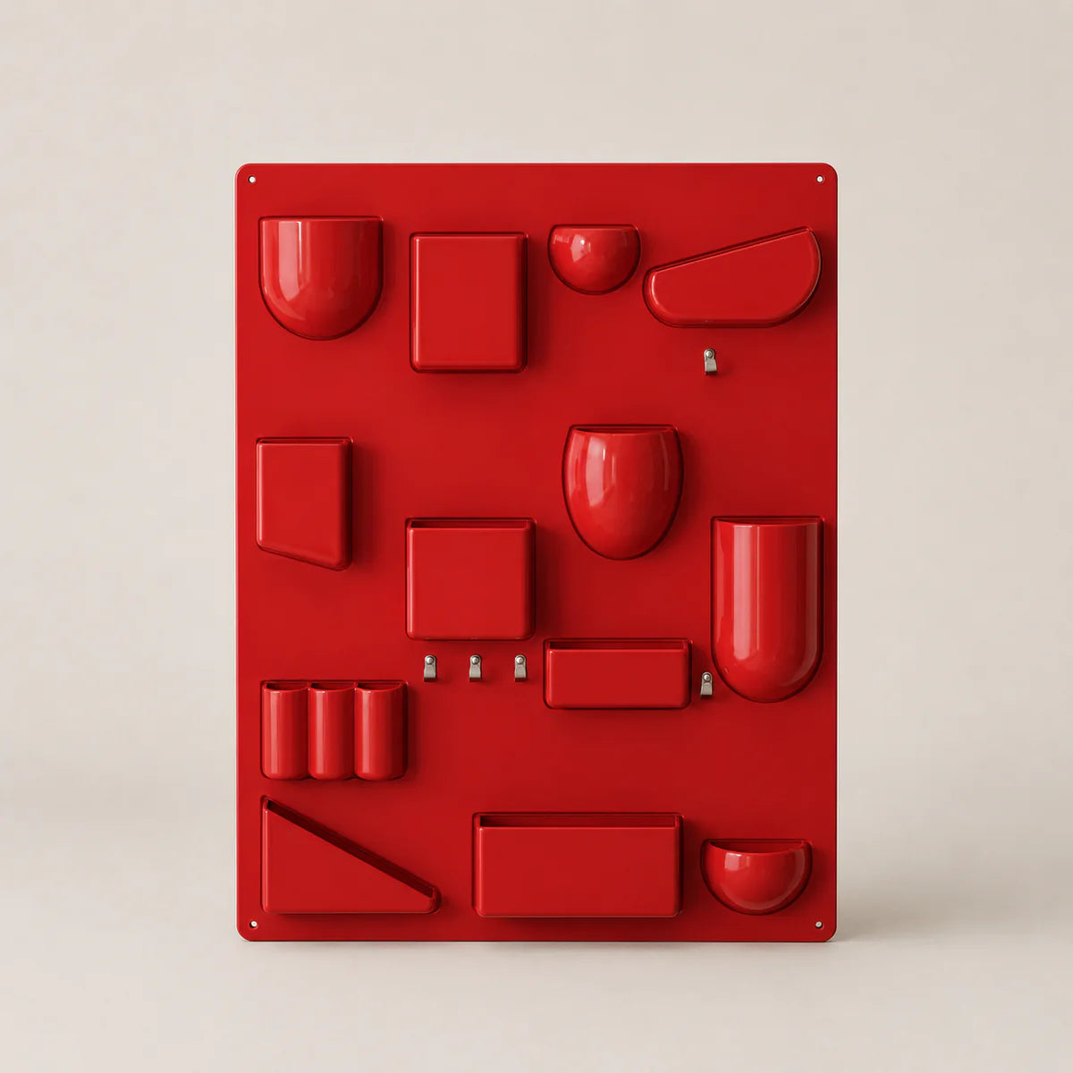 Red wall-mounted organizer with various shaped compartments on a beige background