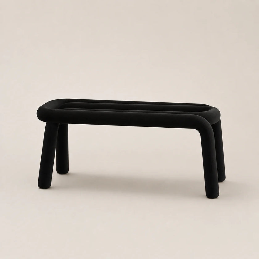 Black rectangular stool on a beige background