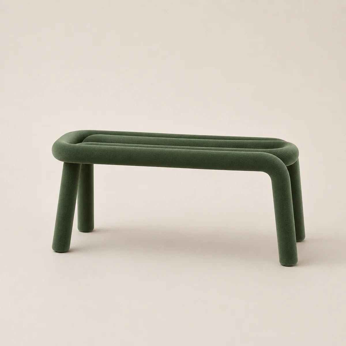 Green stool with curved legs on a beige background