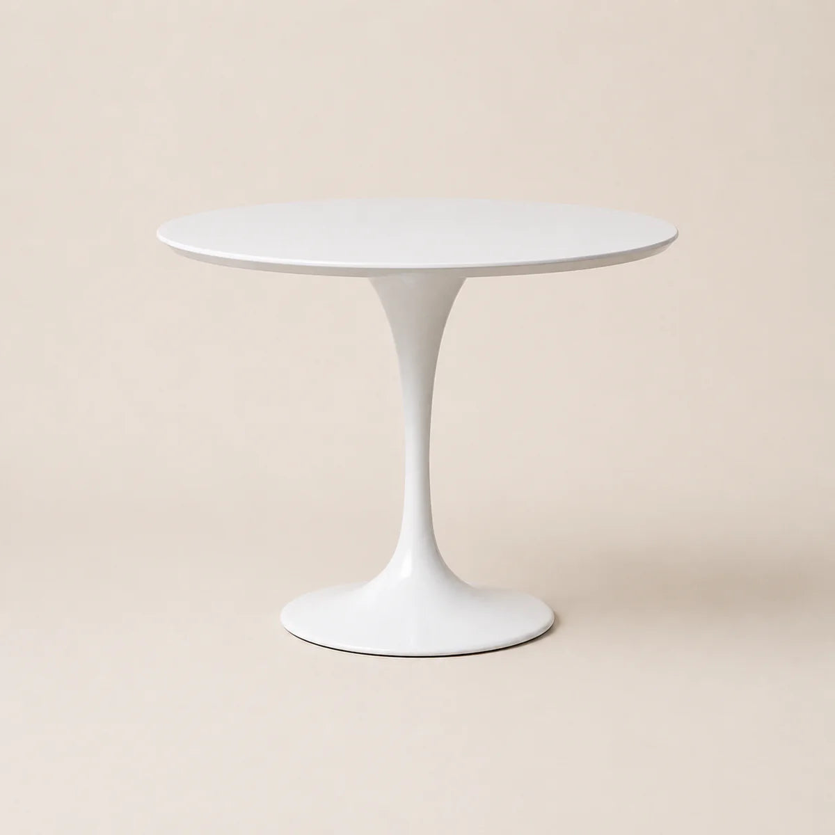 White round table with a pedestal base on a beige background