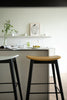 Modern kitchen with counter height bar stools and a white countertop.