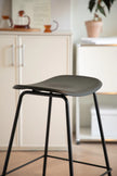 Black bar stool with black legs in a kitchen setting