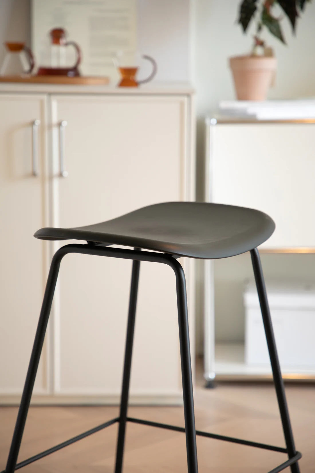 Black bar stool with black legs in a kitchen setting