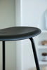 Black bar stool with a blurred background