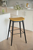 Yellow bar stool with black legs in a kitchen setting