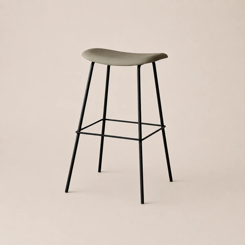 Bar stool with a green seat and black metal legs on a beige background