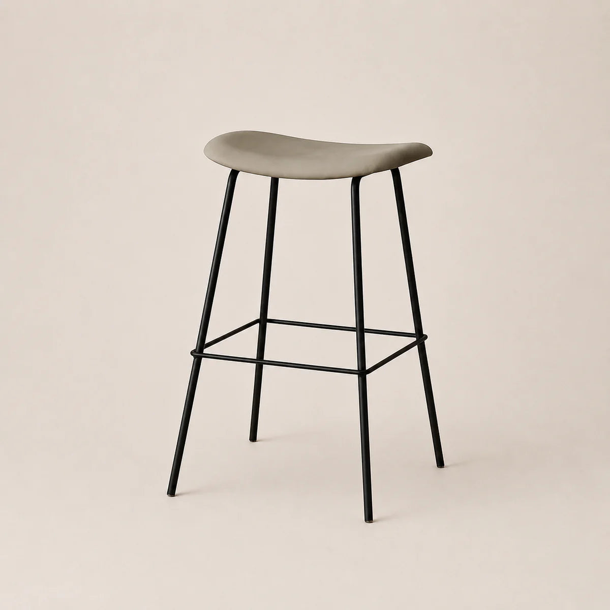 Bar stool with a gray seat and black metal legs on a beige background