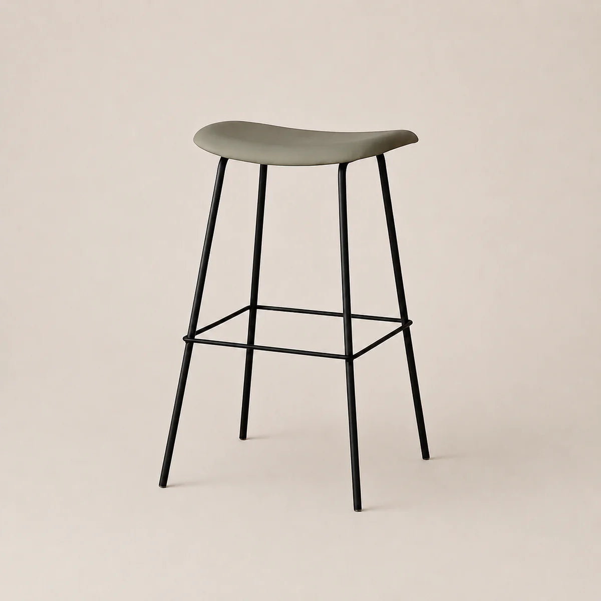 Bar stool with a green seat and black legs on a beige background