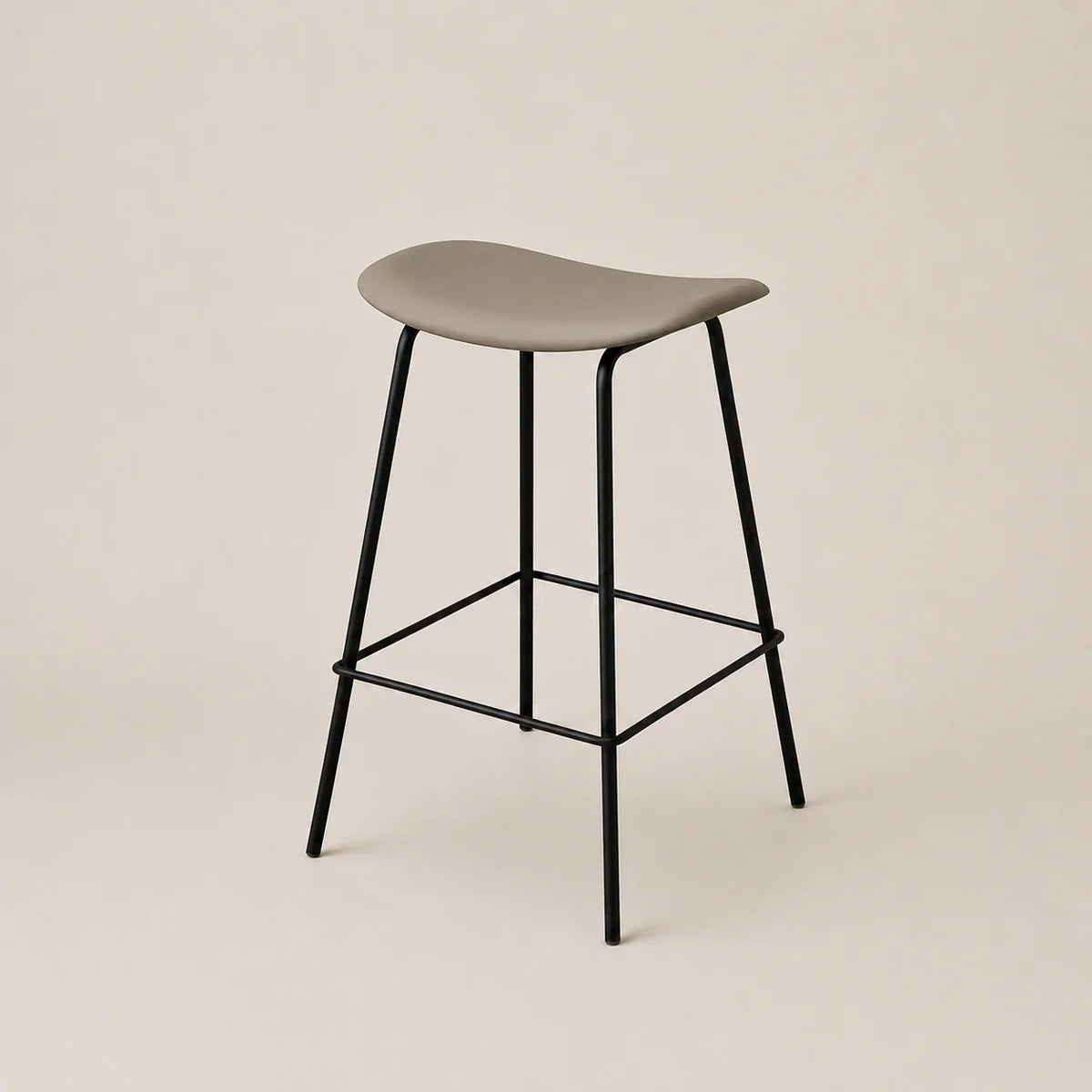 Bar stool with a gray seat and black metal legs on a beige background