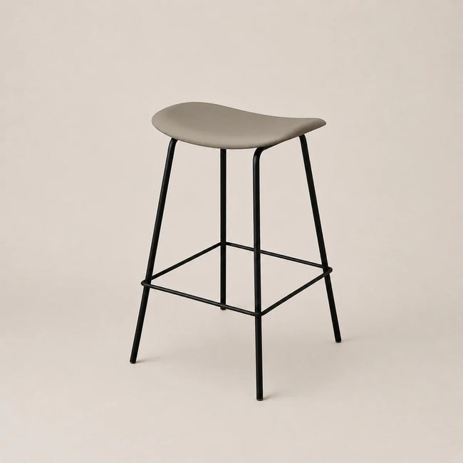 Bar stool with a gray seat and black metal legs on a beige background
