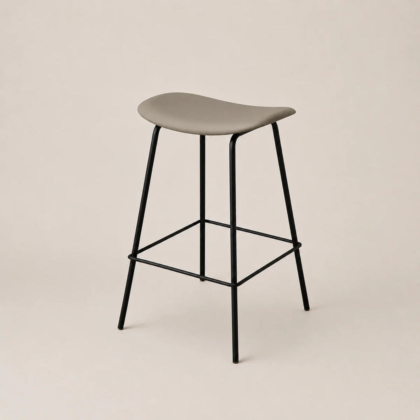 Bar stool with a gray seat and black metal legs on a beige background