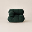 Dark green inflatable chair on a beige background