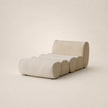 Modern beige sofa with curved design on a plain background