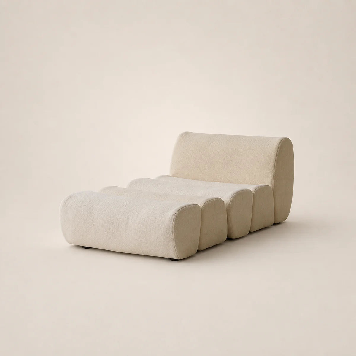 Modern beige sofa with curved design on a plain background