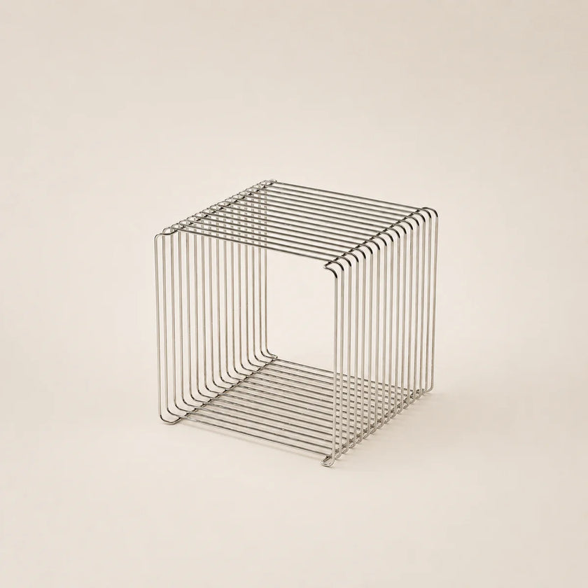 Wire mesh cube on a beige background