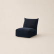 Navy blue bean bag chair on a beige background