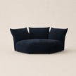 Navy blue sofa with three cushions on a beige background